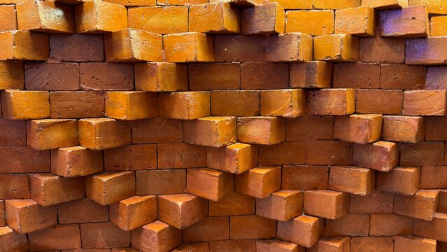 Symmetrical red brick wall pattern in front view, showing uniform structure and texture. Construction background, masonry detail, architectural surface, durable material, building facade concept.