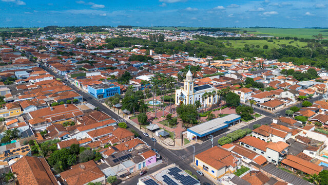 Aerial drone view of Uchoa city in Sao Paulo state, Brazil. Main town square with catholic church, residential neighborhoods and urban landscape of a small Brazilian town.