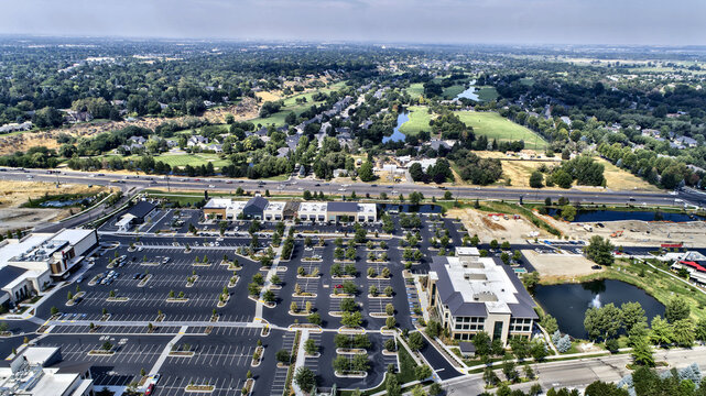 Aerial View of Retail Shopping Center with Large Parking Lot and Highway Access