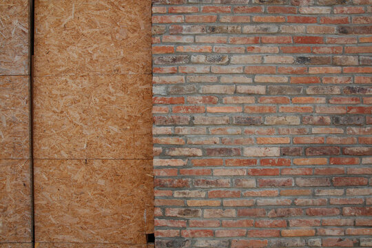 Wood and brick contrast: modern OSB meets classic masonry