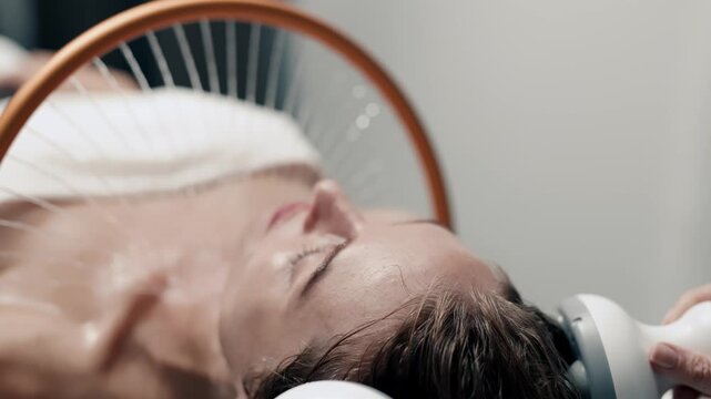Woman experiencing Japanese spa therapy with rotating water stream, wellness concept.
