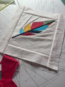 Stylized feather quilt block created with FPP technique, (foundation paper piecing) a Japanese inspired modern patchwork with colorful batik fabrics 