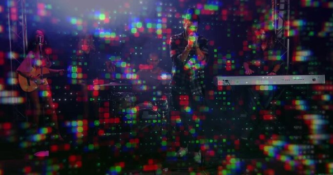 Pixel projection starting, lead singer singing into handheld microphone while band performing song
