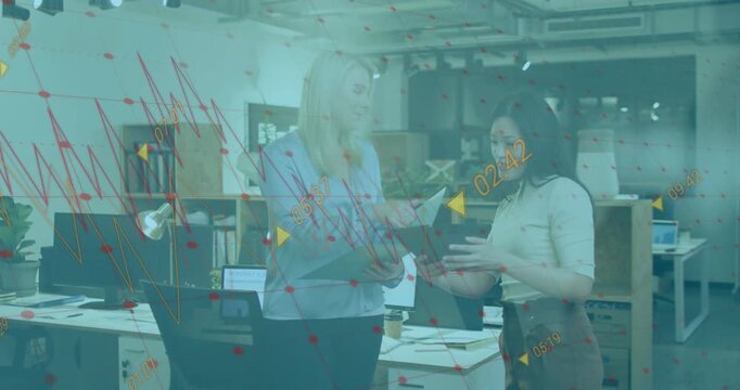 Vertical video: Women upon exchanging papers, reviewing for work with teal overlay animated markers