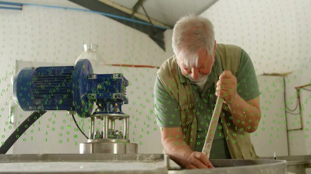 Senior worker inserting rod and stirring tank in plant, checking contents, green digits overlaying