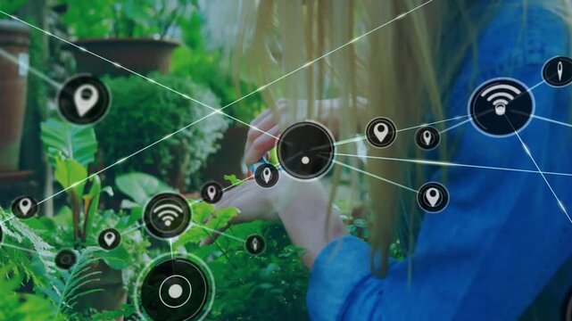 Plant caretaker snipping ferns, activating Wi-Fi and pin icons mapping crop data for agritech
