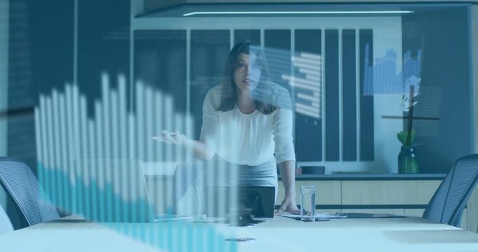 Vertical video: Leading meeting as charts appearing, woman in light blouse skirt pointing at laptop