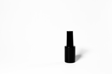 Obraz premium Black bottle of nail polish isolated on white background
