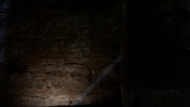 Sacred corridor inside the Abydos Temple illuminated by natural light, revealing detailed carvings and timeless Egyptian heritage. Egypt.