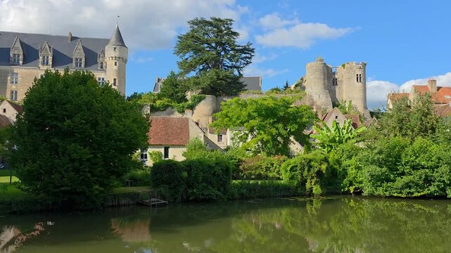 Quaint village of Montresor in the Loire Valley of France. Slow panning motion. Chateau with reflections in the Indrois River.