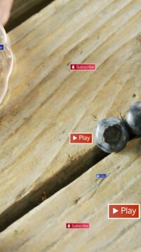 Vertical video: Blueberries on wood plank, red UI badges popping, cup sliding in, driving clicks