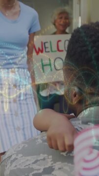 Vertical video: Soldier arriving door, child running hugging him, homecoming with sign and US flag