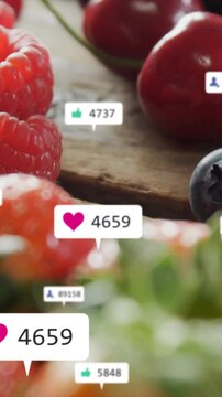 Vertical video: Heart bubble appearing, badges drifting on berries, updating, showing rising likes