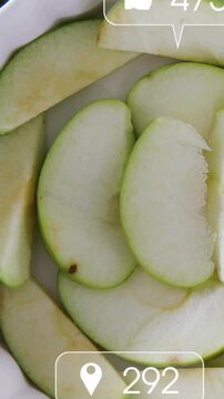 Vertical video: Apple slices sitting in bowl after 2 frames social icons overlaying counts for ads