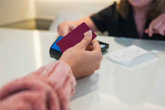 Customer paying medical bill with credit card at clinic