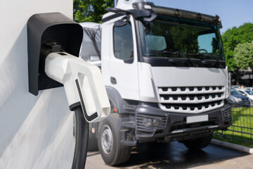 Electric vehicles charging station on a background of a truck
