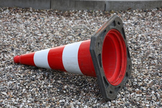 Red white cone flaying on the ground