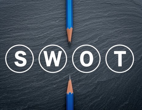 Swot analysis concept with blue pencils on a dark slate background