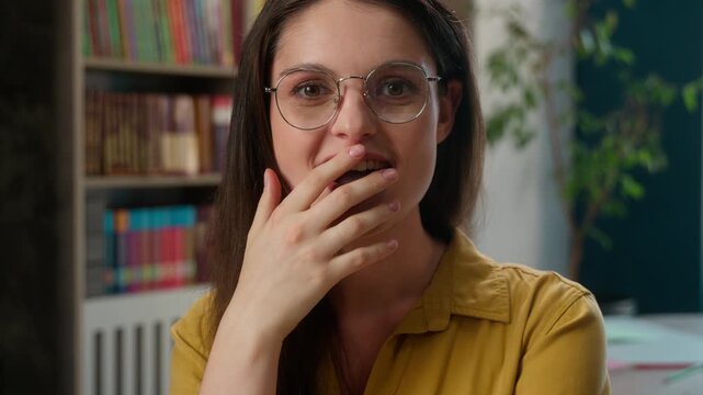 Happy smiling Caucasian woman student girl celebrating success excited young female in glasses rejoice passing exam test education result shock high school pupil university studying achievement indoor