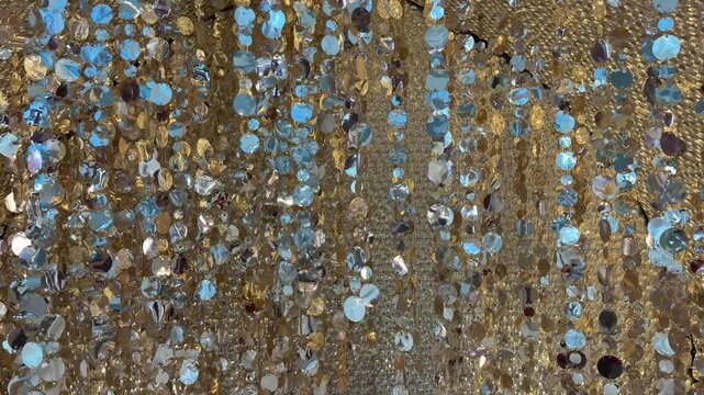 4K footage of sparkling round tinsels and slingers hanging from ceiling. Decoration and embellishment for festival and seasons greetings. Reflective and mirror tassels 