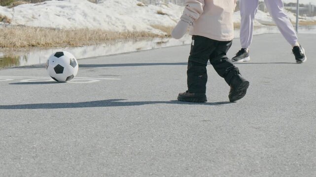 A fan walks with anticipation towards a weekend football match in the community