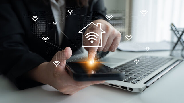 A user interacts with a smartphone device in a modern office, showcasing smart home technology with Wi-Fi signals connecting to various devices for convenience. Gantry