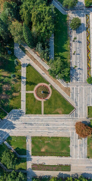 Top-down aerial view of geometric park alleys and flower beds