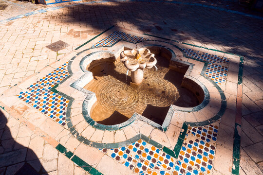 A beautiful ornate fountain inside the Alcazar of Seville in Spain.