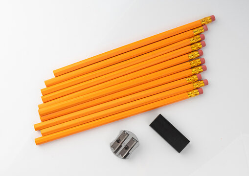 Pencils with a rubber isolated. Unsharpened yellow wooden graphite pencils