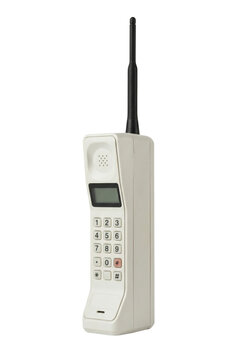 Vintage brick cell phone side view isolated. Retro telecommunication device.