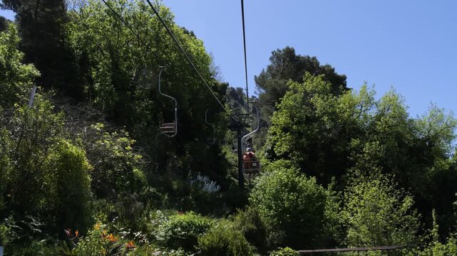 Mount Solaro chairlift ascending through gardens on Capri Island, Italy
