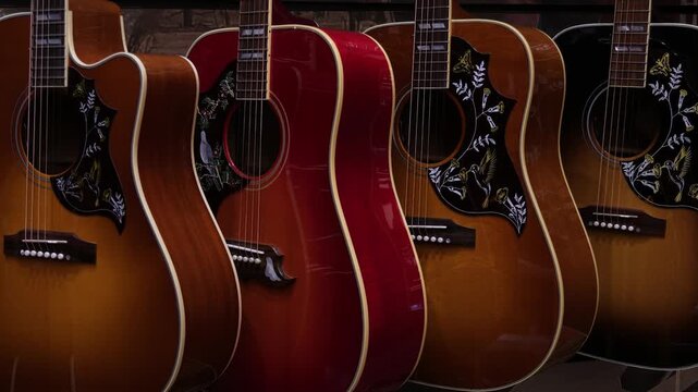 Polished wooden acoustic guitars in a row