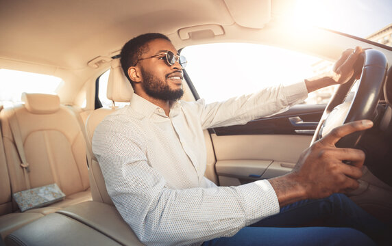 African american man driving car, going to work place, free space