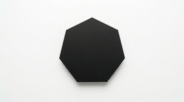 A clean black heptagon isolated on a bright white surface, sharp angular edges forming a precise seven-sided silhouette, minimalist composition with subtle soft shadow grounding the shape,