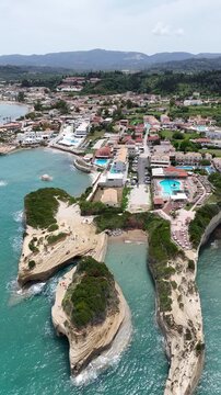 Sidari, Corfu, Greece: Famous Canal d'Amour rock formations and turquoise waters. Stunning sandstone cliffs, natural sea caves, and beautiful Mediterranean beach landscape during a bright sunny day.