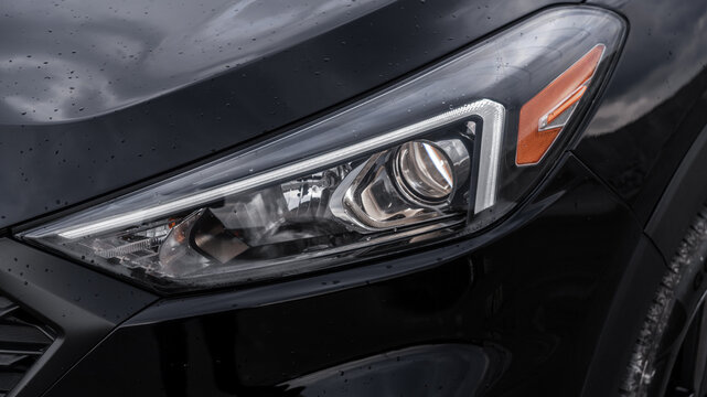 clean headlight of a black modern car after car wash. car wash, detailing studio, interior dry cleaning