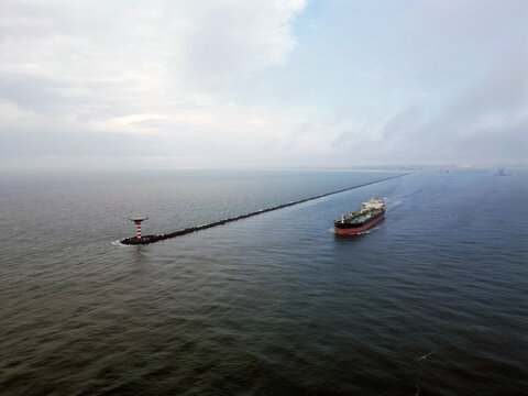 Aerial view of a empty oil tanker leaving the port of Rotterdam