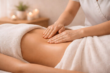 Naklejka premium Side view of manual lymphatic drainage massage on the abdomen in a spa room. Light repetitive movements demonstrate a wellness treatment for detox support and swelling reduction