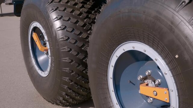 Large new all-terrain vehicle wheels with centralized automatic air inflation. Closeup. Shot in motion 