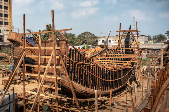 Construction of traditional wooden crescent moon boats in Chittagong.