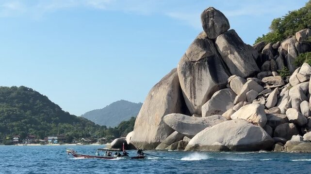 Traditional Thai Boat Sailing by Island Rocks in Koh Tao