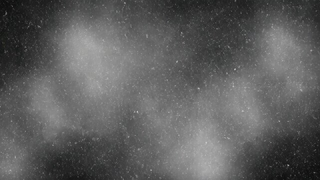 An abstract grayscale grain texture delivers diffuse ambient lighting and scattered noise inspired by vintage film grain in a moody background composition.