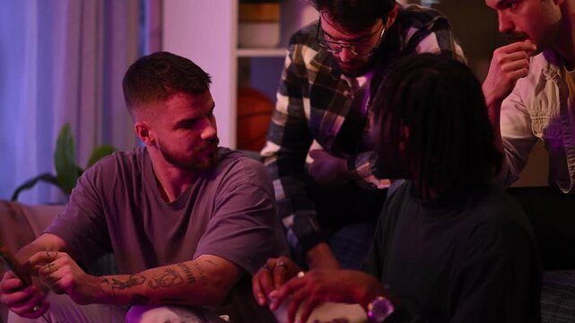 Diverse male friends gathering at home, sharing stories and laughing together. Young men enjoying a relaxed evening with snacks and drinks