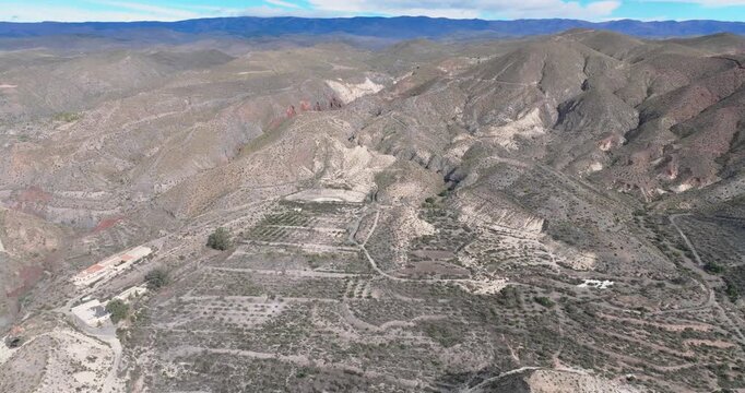Aerial tracking over desert ridges and valleys Tabernas Spain dry cinematic landscape