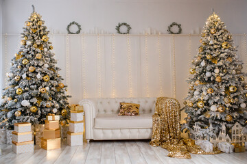 Luxury white Christmas interior with two trees and gold decorations © TetianaRUD