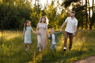 Active Family Enjoying Fitness Adventure During Evening Hours Outside. Caucasian Family Engaging In Energetic Jog Along Rural Path At Sunset With Lively Shadows And Health Focus © Kaplitskaya Love