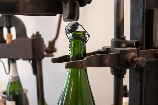 Old equipment for packaging champagne bottles, caps and muselet wire cage, traditional method making champagne sparkling wine in Reims, France