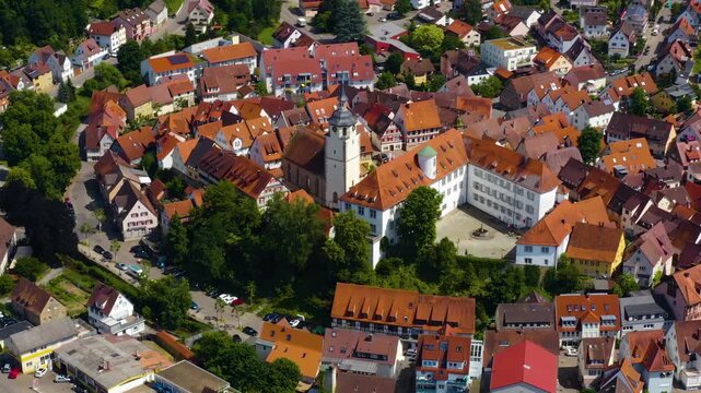 An panoramic aerial view around the old town in the city Waldenbuch on a sunny summer noon in Germany .