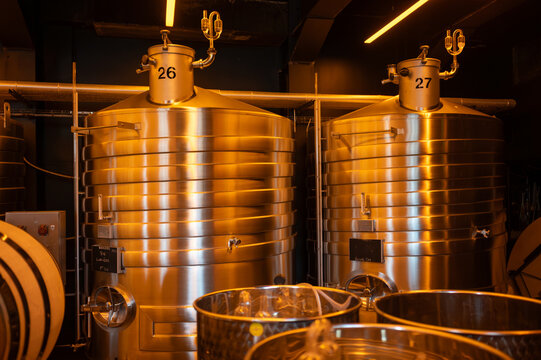 Visit of modern underground caves with steel tanks for fermentation and oak barrels for aging og wine, traditional method making champagne sparkling wine in Reims, Champagne, France