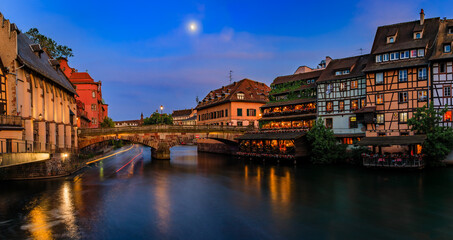 Obraz premium Half timbered houses by canals of Petite France in Strasbourg, France at sunset